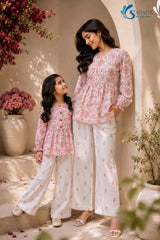 Bloom & Breezy Mom & Me Co-ord Set candid pose featuring matching floral printed peplum tops and white printed palazzo pants for stylish mother and daughter ethnic wear by Saivalya.