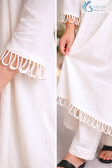Close up shot of the Saivalya Ivory Loop Grace Suit focusing on the delicate loop button closures and the high quality fabric texture of the ivory outfit