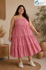 Full-length front view of a smiling woman posing on a round jute rug in a warm bohemian room, wearing the Raspberry Striped Tiered Midi Dress styled independently without the inner layer, showcasing its straight neckline, thin straps, pink striped tiered flared skirt, and white sneakers.