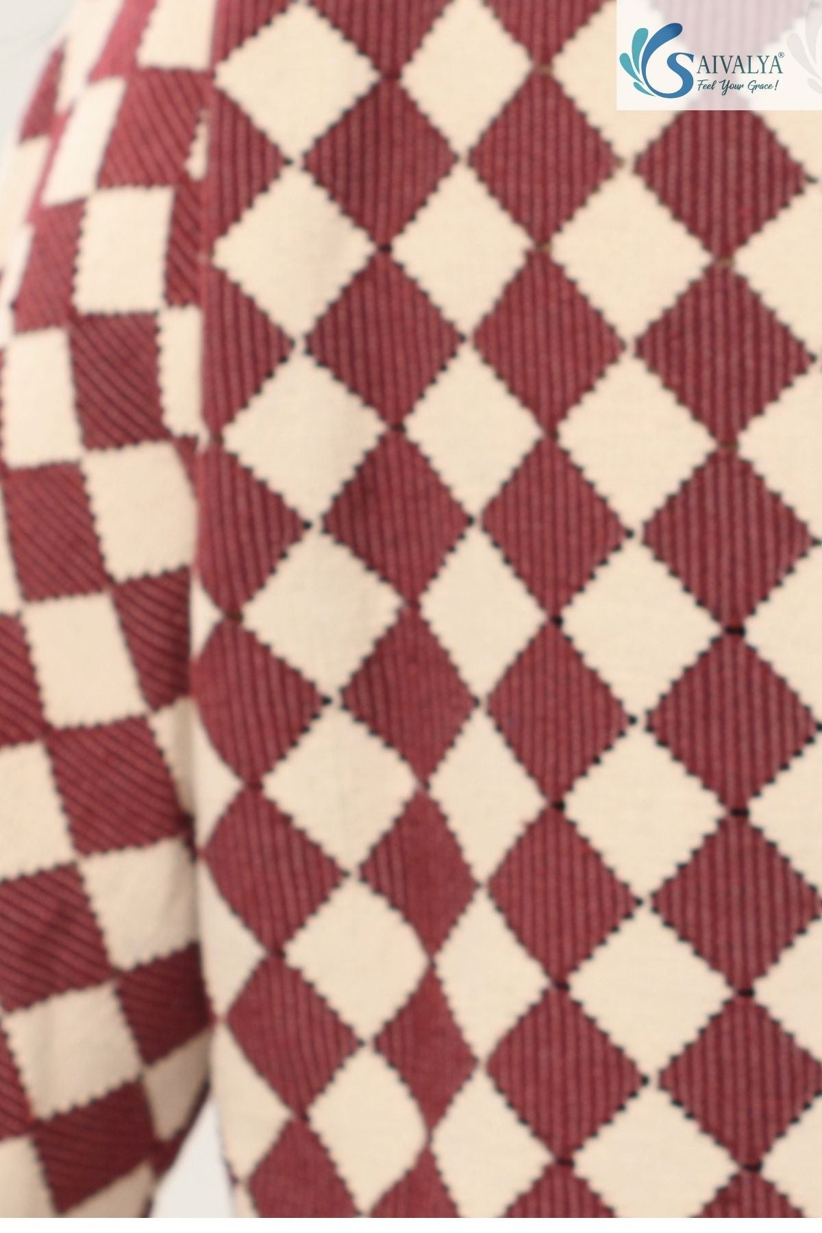 A macro close-up of the Shatranj Maroon Bell Top, showing the detailed knit texture of the fabric. The maroon and cream harlequin diamonds feature a fine ribbed or corded weave, highlighting the high-quality, mid-weight feel of the material.