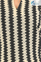 close view of a woman wearing Saivalya black and white vertical chevron print Ottoman jacquard knit top.
