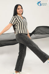side view of a woman wearing Saivalya black and white vertical chevron print Ottoman jacquard knit top with a polo collar