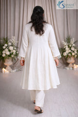 Back view of a woman wearing the Saivalya Ivory Loop Grace Suit showcasing the sophisticated fit and the flow of the ethnic ivory suit set