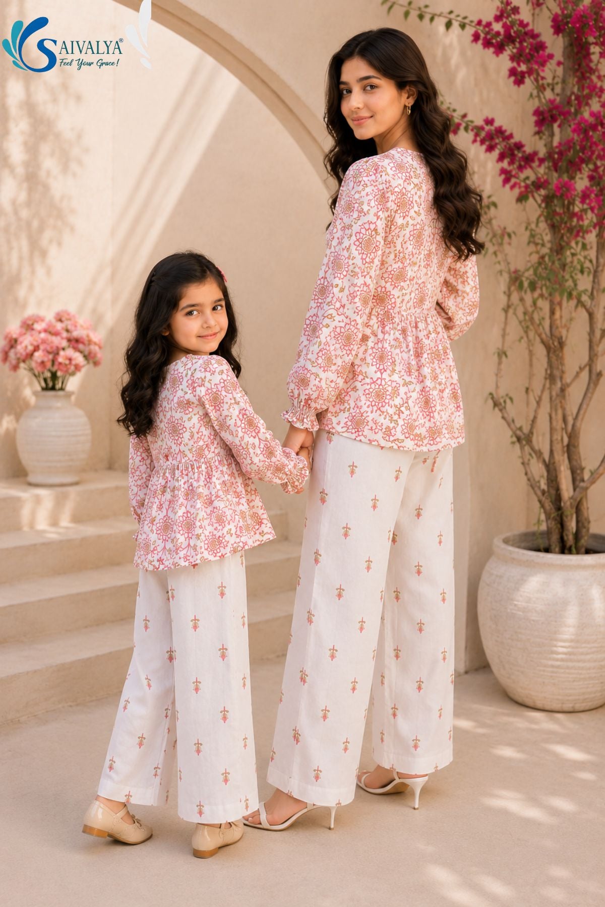 Back view of Bloom & Breezy Mom & Me Co-ord Set featuring matching floral printed peplum tops and white printed palazzo pants for mother and daughter ethnic wear by Saivalya.
