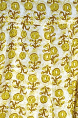 Close-up view highlighting the detailed olive-yellow and brown block-style floral print on white cotton fabric from the Citrus Blossom Kalidar Kurta Set.