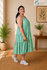 Close up shot of the Saivalya Verdant Muse green striped tiered midi dress showcasing the vertical stripe pattern and high quality fabric texture