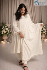 Front view of a woman wearing the Saivalya Ivory Loop Grace Suit featuring intricate loop button details and matching dupatta paired with straight fit trousers