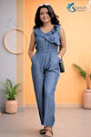 Full-length shot of a model wearing a Saivalya indigo blue cotton denim jumpsuit with ruffle neck detail.