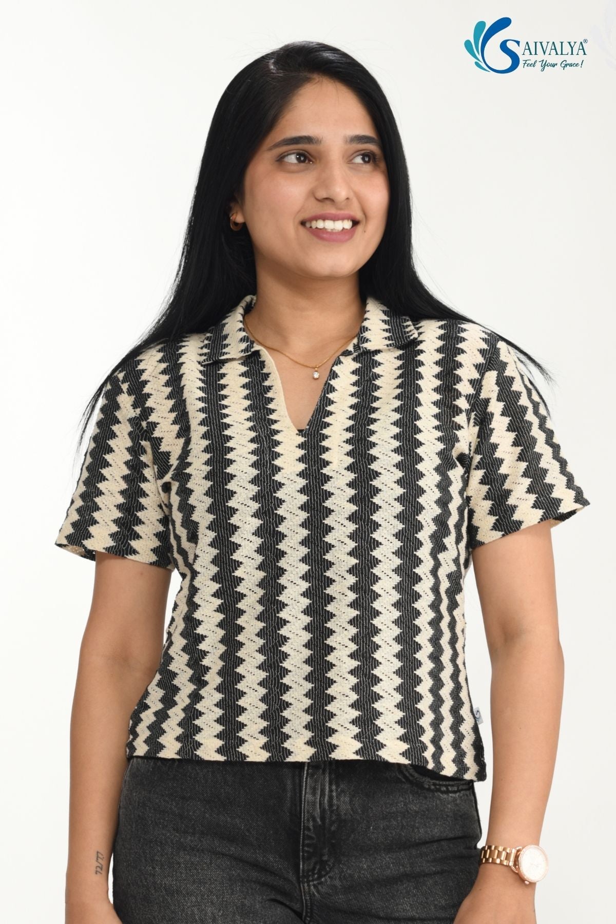 front view of a woman wearing Saivalya black and white vertical chevron print Ottoman jacquard knit top with a polo collar